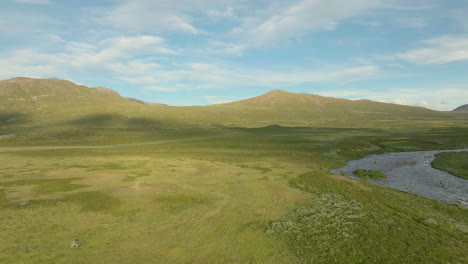 Aerial-shot-of-vast-green-meadows-in-Scandinavian-countryside---relaxing-scene