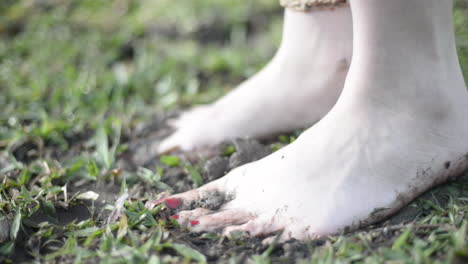Young-woman´s-feet-stepping-in-mud-and-grass