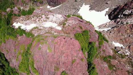 Aerial-Rotating-Pan-Down-Hiker-on-a-Summit---Mackenzie-Range,-Vancouver-Island,-BC,-Canada