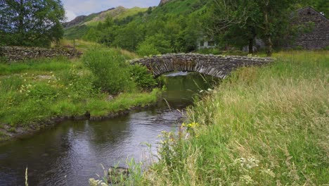 Video-footage-of-the-hamlet-of-Watendlath's-attractive-packhorse-bridge-sitting-over-the-Watendlath-beck,-this-is-the-source-for-Lodore-Falls-–-a-tourist-attraction-from-Victorian-times