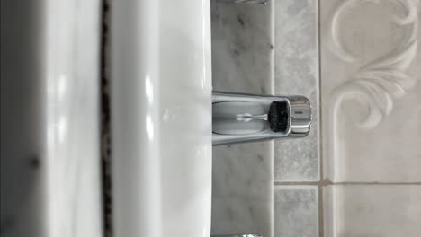The-faucet-dripping-water-vertical-format
