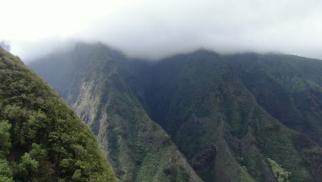 Cinematic-drone-footage-rising-above-the-lush-green-mountain-ridges-of-Maui
