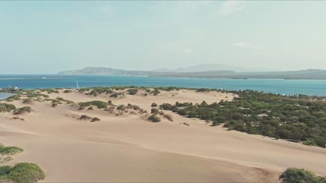 Aerial-view-overlooking-the-Dunes-of-Bani-in-Dominican-Republic---pan,-drone-shot