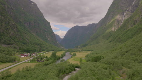 Aerial-up-scenic-Gudvangen-Valley---Kjelfossen-cascading-down-steep-mountainside