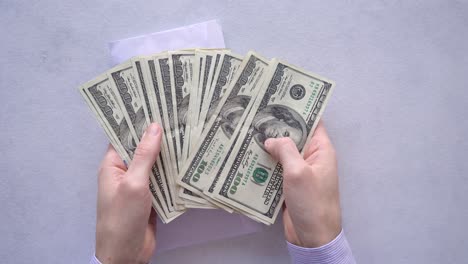 Man-Open-And-Took-Out-The-One-Hundred-Dollar-Bills-From-The-Envelope