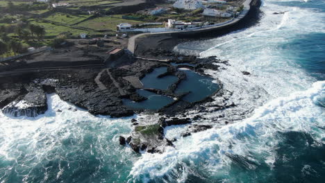 Fantastic-aerial-shot-of-the-coast-of-Agaete-and-specifically-of-its-natural-pools-where-the-ocean-breaks-the-coast-with-force