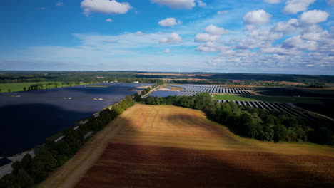 Aerial-Panorama-Of-Solar-Power-Plant-With-Beautiful-White-Clouds-In-Countryside
