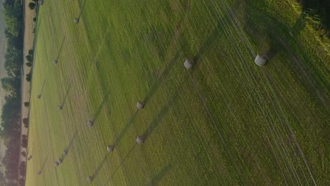 Aerial-flight-over-a-beautiful-hay-field-in-the-midwest-near-sunset-in-vertical-format