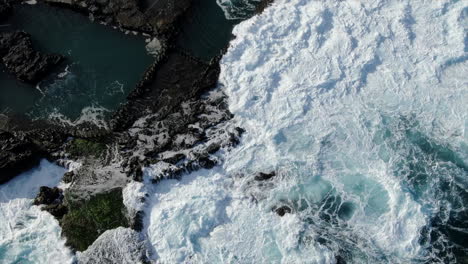 Fantastic-aerial-shot-from-above-and-at-half-height-of-the-coast-of-Agaete-and-specifically-of-its-natural-pools-where-the-ocean-breaks-the-coast-with-force