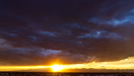 Sunrise-on-a-stormy-day-with-dark-clouds-threatening-rain-in-the-Mojave-Desert---time-lapse