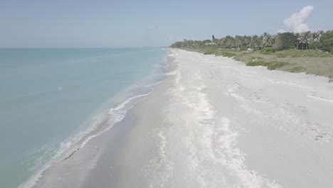 Drone-shot-flying-over-empty-sand-beach-on-Sanibel-Island-in-Florida