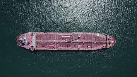 Empty-Cargo-Ship-Anchored-Still-in-Ocean,-Aerial-Top-Down-Drone-View