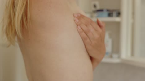Side-view-of-woman's-hand-check-breast-for-lumps-in-breast-cancer-exam