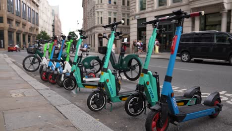 London-England-September-2022-Row-of-electric-scooters-waiting-for-users-by-side-of-road