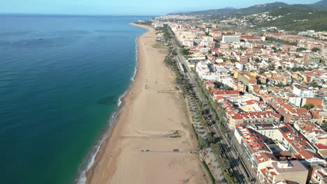 Aerial-image-of-Malgrat-de-Mar-beach-in-the-province-of-Barcelona-beach-without-people-transparent-turquoise-blue-sea