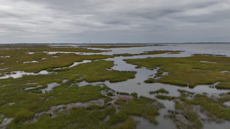 A-low-altitude,-aerial-view-over-the-salt-marshes-in-Hempstead,-NY-on-a-cloudy-day-1
