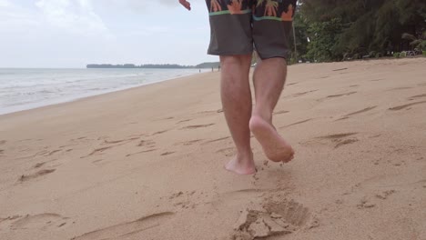 POV-of-man-walking-with-barefoot-on-white-sand-beach-in-slow-motion-in-summer-holiday-vacation
