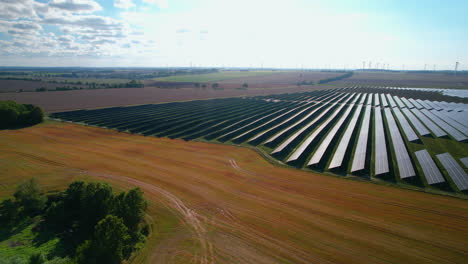 Aerial-View-Of-Large-Scale-Solar-Farm-On-Clear-Sunny-Day-In-Countryside