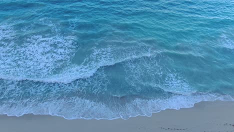 Descending-Aerial-Shot-With-Pan-Up-Revealing-The-Rest-Of-The-Ocean