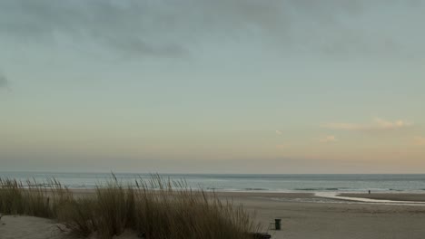 Wide-scene-of-lonely-man-shore-fishing-in-the-golden-hour-at-Costa-da-Caparica