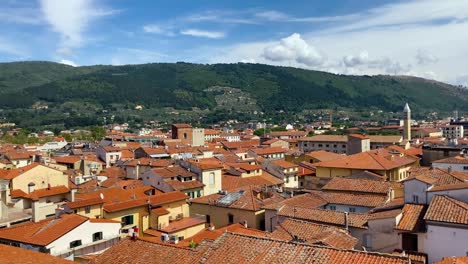 Shooting-Prato-seen-from-above:-roofs,-buildings,-people,-sky-and-mountain
