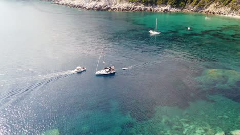 Aerial-Static-Shot-Showing-Two-Boats-Sail-Past-Each-Other-Off-The-Coast-Of-Greece