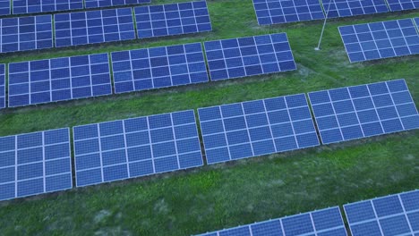 Aerial-drone-flyover-solar-panels-on-grass-field