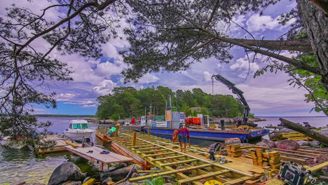 Time-lapse-of-workers-constructing-riverside-wooden-pier-under-moving-cloudscape