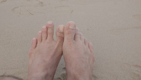 Pov-to-barefeet-while-relaxing-on-white-sand-beach-near-sea-in-summer-vacation-holiday-time-in-Phuket,Thailand-in-early-morning