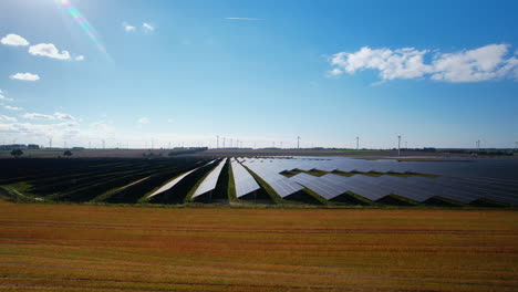 Aerial-Flying-Towards-Large-Scale-Solar-Farm-On-Clear-Sunny-Day