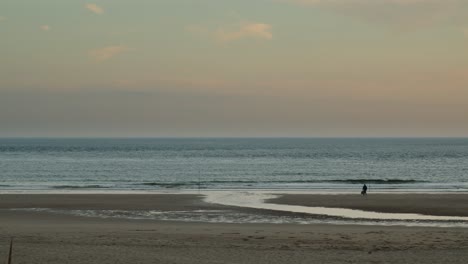 Lonely-man-shore-fishing-in-the-golden-hour-at-Costa-da-Caparica