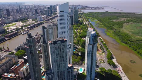 Flying-backwards-drone-shot-of-skyscrapers-in-Puerto-Madero,-Buenos-Aires