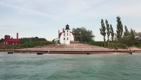 Historic-Point-Betsie-Lighthouse-in-Frankfort,-Michigan-located-along-Lake-Michigan-with-drone-video-wide-shot-low-moving-sideways