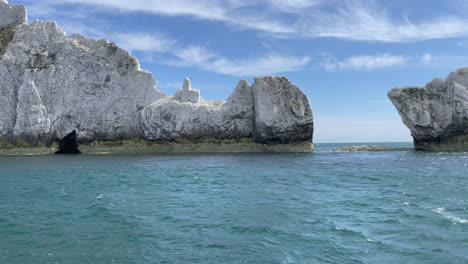 Fast-dolly-shot-showing-the-white-cliffs-called-the-Needles-on-the-coast-line-of-the-Isle-of-Wight,-bright-sunny-day