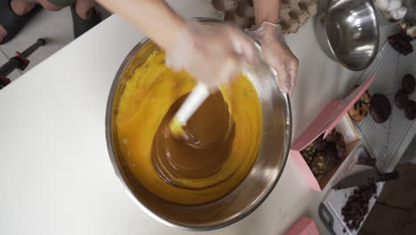 Baker-Stirring-Cookie-Mixture-With-Butter-And-Sugar-In-A-Mixing-Bowl