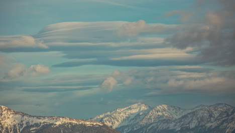 Clouds-forming-and-dissipating-above-the-snowy-alpine-mountain-landscape---time-lapse