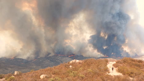 Dramatic-wildfire-landscape,-Huge-smoke-plumes-in-background,-Moutain-hills-burning,-Fairview-Fire,-California