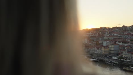 A-tourist-taking-photos-of-the-sunset-in-the-city-of-Porto,-in-Portugal