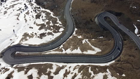 A-unique-black-tarmac-road-with-twists-and-turns-through-a-snowy-scene