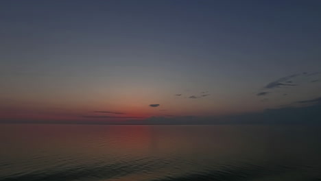 Timelapse-shot-of-colorful-sky-after-sunset-over-sea-water-during-evening-time