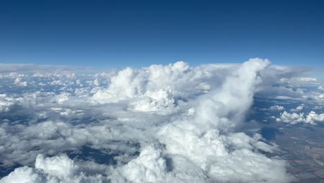 Nice-aerial-view-from-a-jet-cockpit,-pilot-point-of-view-flying-through-a-turbulent-Spring-sky-full-of-cumulonimbus