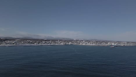 Drone-shot-sea-and-coastal-town-on-Hokkaido-island-in-Japan-in-winter