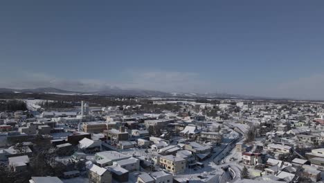 Establishing-aerial-shot-snow-covered-town-in-suburban-Japan