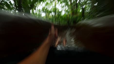 POV-shot-of-a-tourist-sliding-on-a-jungle-waterslide-in-the-costa-rician-rain-forest