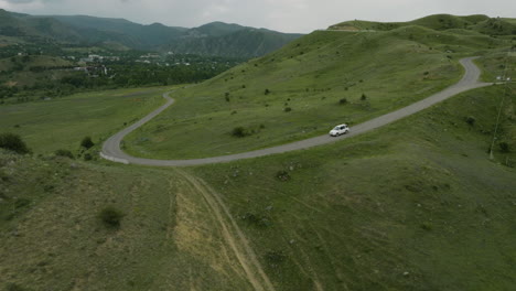 White-SUV-Car-Driving-On-Countryside-Road-In-Rural-Georgia-At-Daytime