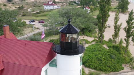 Historic-Point-Betsie-Lighthouse-in-Frankfort,-Michigan-located-along-Lake-Michigan-with-drone-video-circling