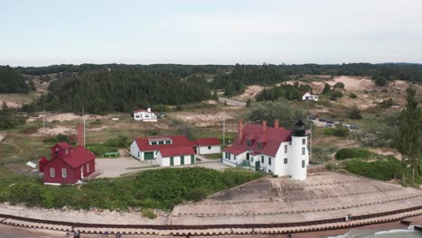Historic-Point-Betsie-Lighthouse-in-Frankfort,-Michigan-located-along-Lake-Michigan-with-drone-video-wide-shot-moving-in