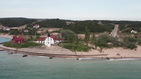 Historic-Point-Betsie-Lighthouse-in-Frankfort,-Michigan-located-along-Lake-Michigan-with-drone-video-wide-shot-moving-sideways