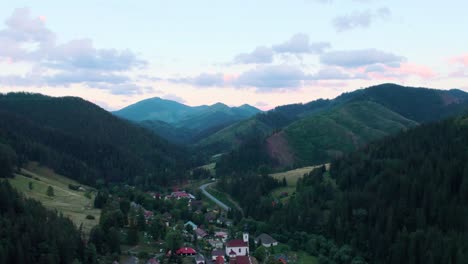A-4K-cinematic-aerial-drone-shot-flying-over-an-eastern-European-mountain-village-in-Maluzina,-Slovakia-at-dusk