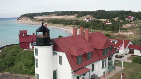 Historic-Point-Betsie-Lighthouse-in-Frankfort,-Michigan-located-along-Lake-Michigan-with-drone-video-close-up-moving-in.